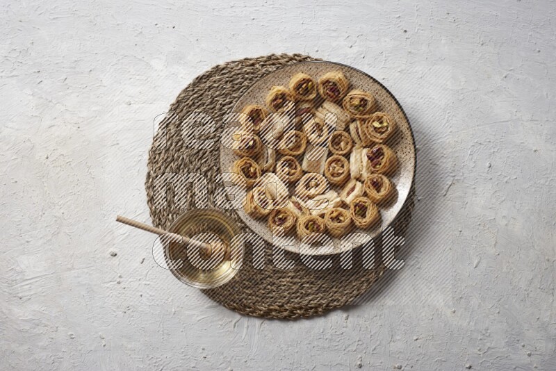 Oriental sweets in pottery plates with honey in a light setup