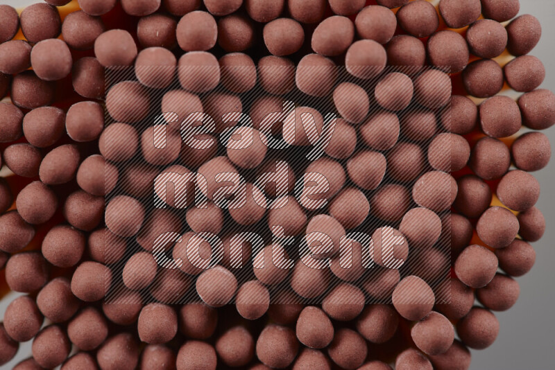 A close-up of a bundle of matches on grey background
