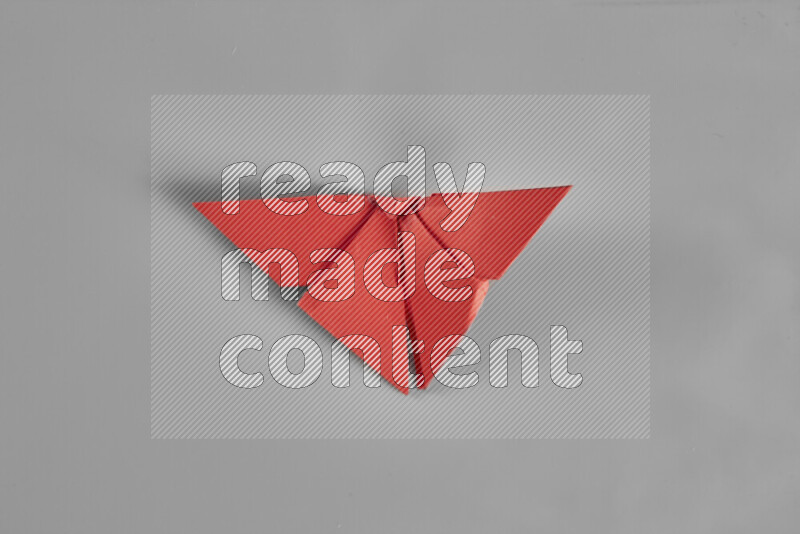 Origami butterfly on grey background