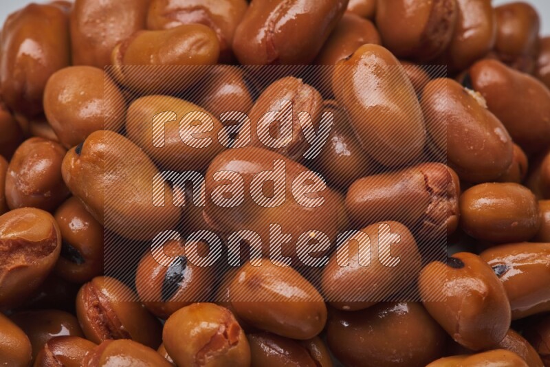 Close up shot of cooked fava beans (foul) on white background