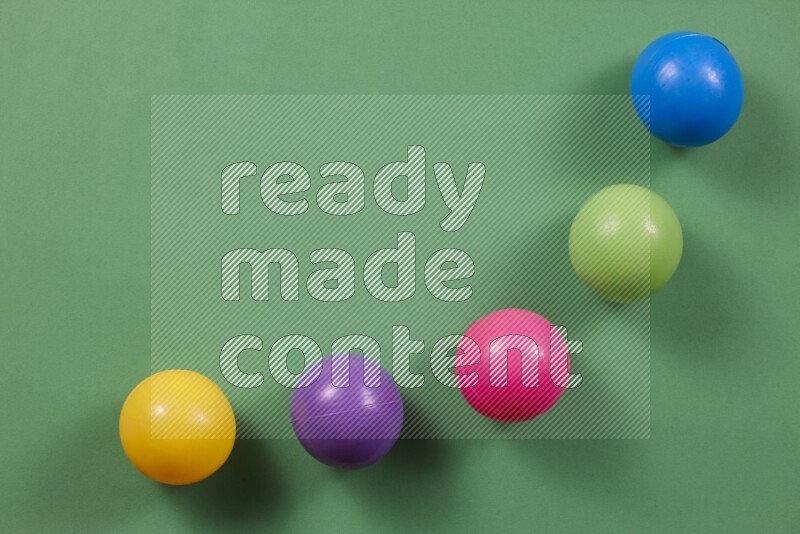 Multicolored plastic balls on different colored backgrounds (kids toys)