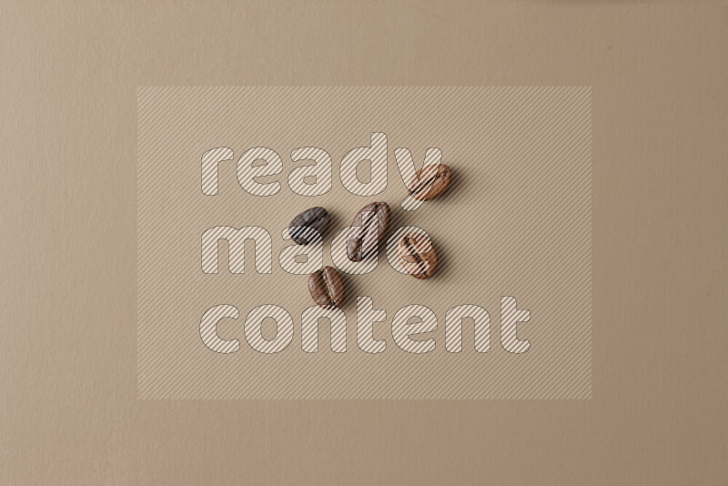 Roasted coffee beans on beige background