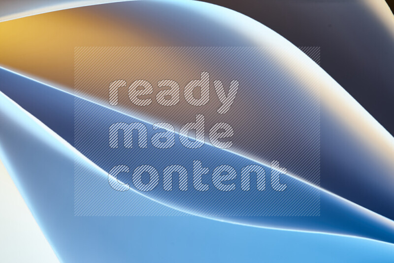 هذه الصورة تعرض تكوين فن الورق التجريدي مع منحنيات ورقية بتدرجات اللون الأزرق والأصفر المكونه بواسطة الضوء الملون