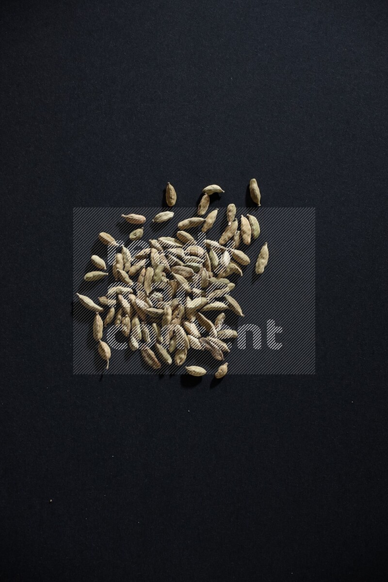 Cardamom seeds on black flooring