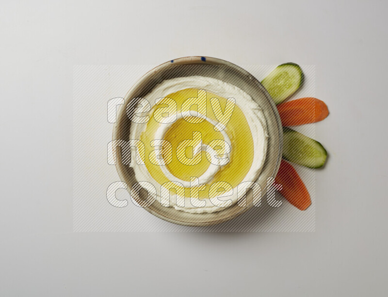 Lebnah garnished with olive oil in a grey pottery plate on a white background