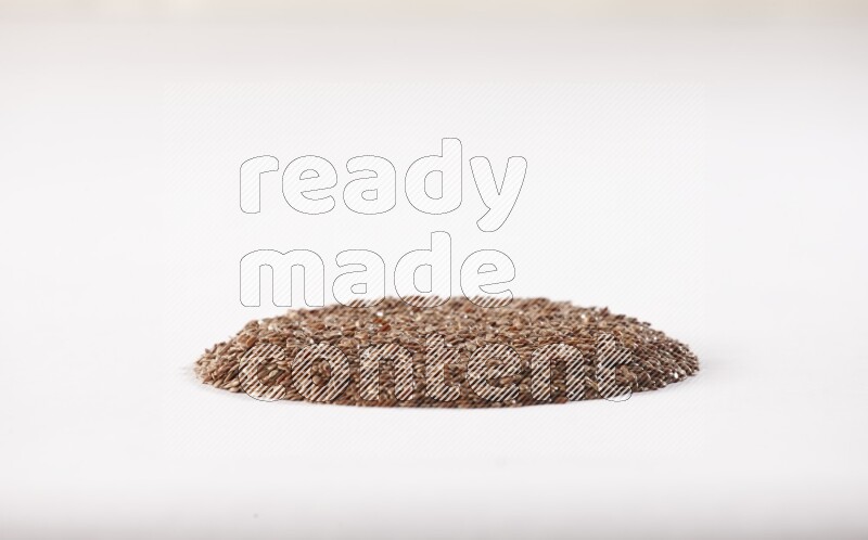 Flax seeds in a circle shape on a white flooring
