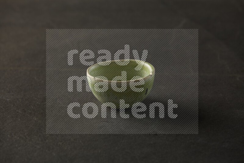 multi color round sauce bowl on grey textured countertop