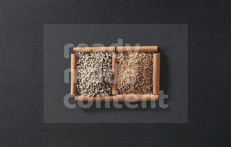 2 squares of cinnamon sticks full of mustard seeds and white peppers on black flooring