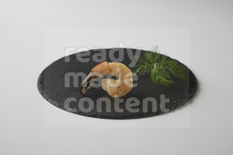 one  grilled shrimp  on a black slate direct  on a white back ground