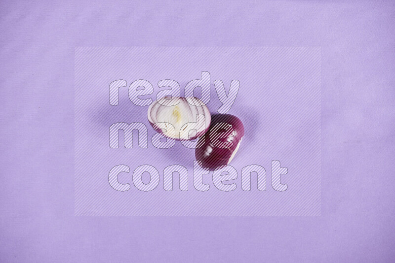 Halves red onions on a purple background