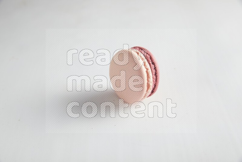 45º Shot of Pink Litchi Raspberry macaron on white background