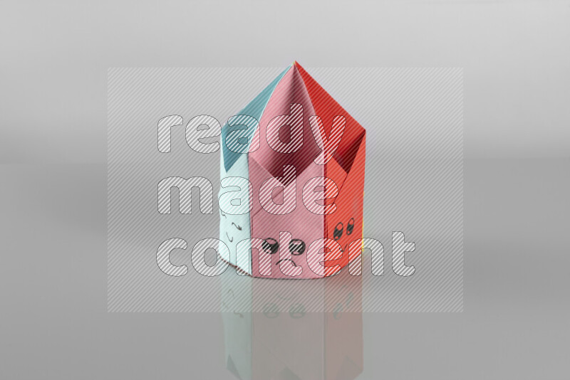 Origami pen holder on grey background