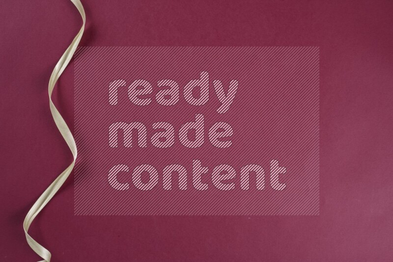 A green and red collection of sewing and tailoring tools arranged on a red background