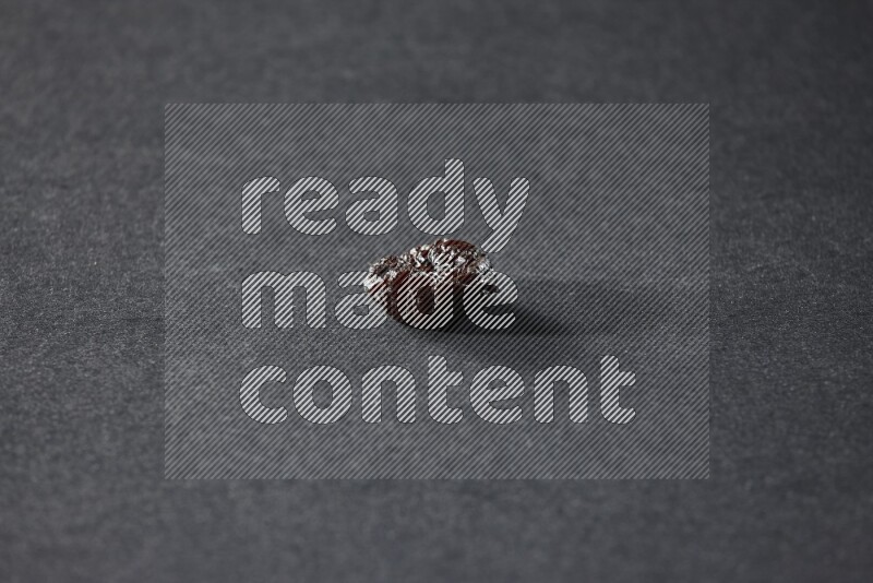 A dried plum on a black background in different angles