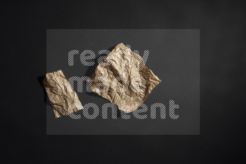 Crumpled craft paper on black background