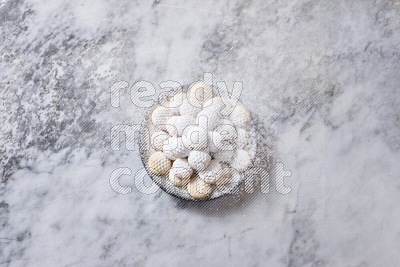 Kahk in black pottery plate on grey marble background