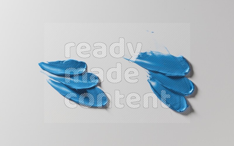 Blue painting knife strokes on white background