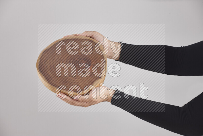 A woman in black abaya holding different wooden essentials in different positions