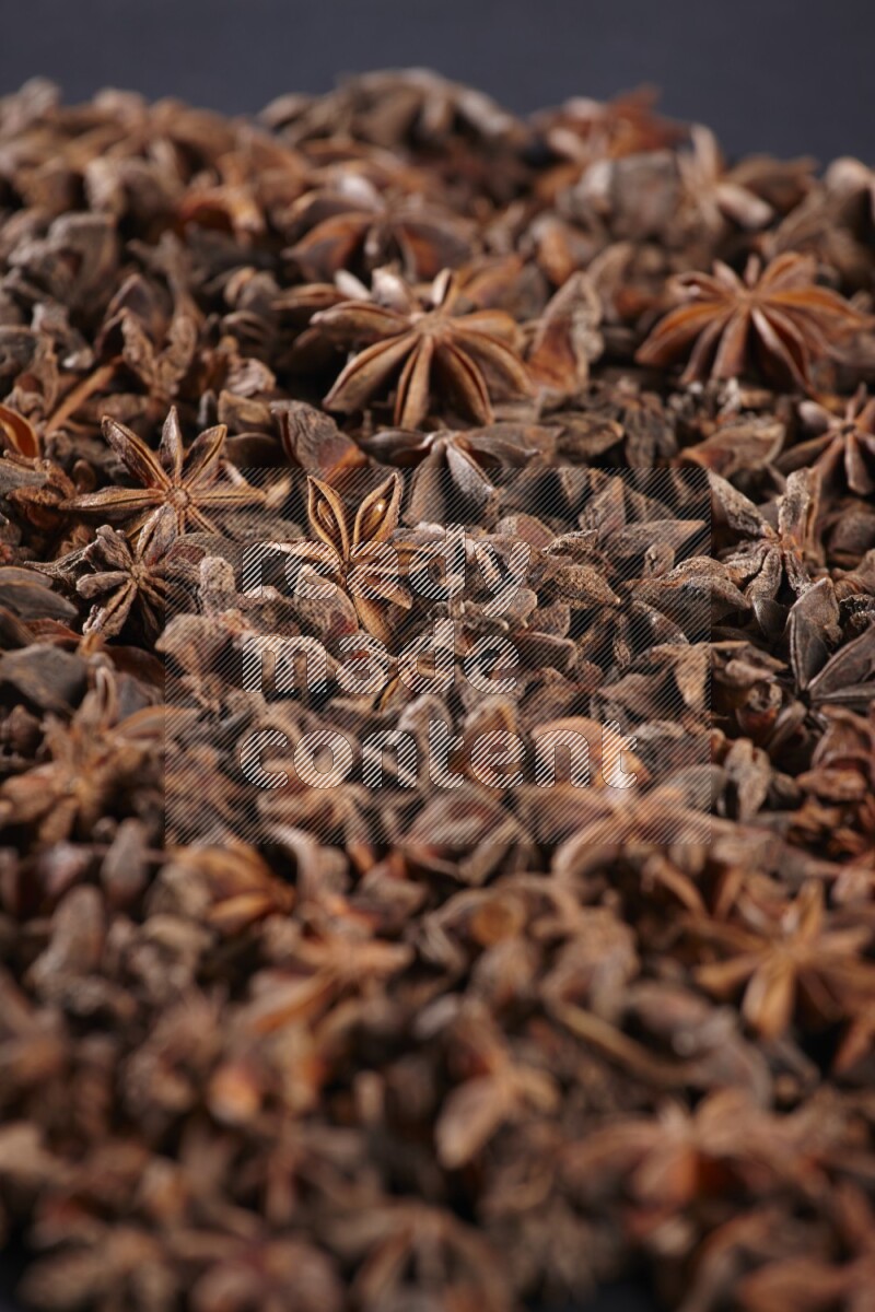 Star Anise herbs fill the frame on black flooring