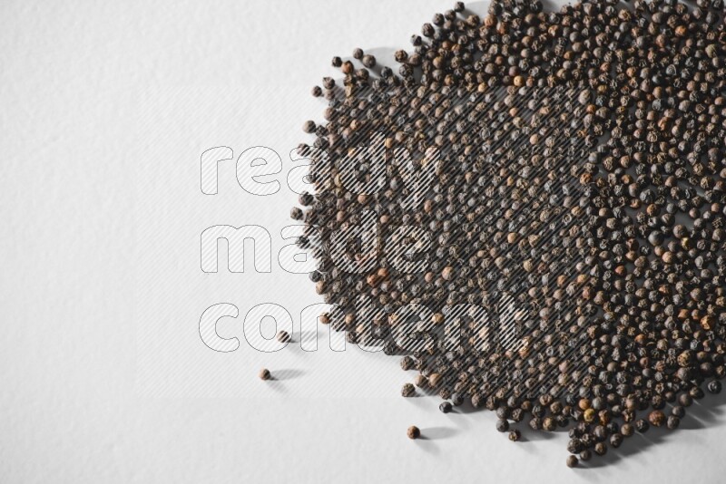 Black pepper on a white flooring