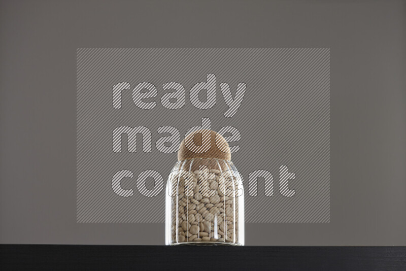 Lupin Beans in a glass jar on black background