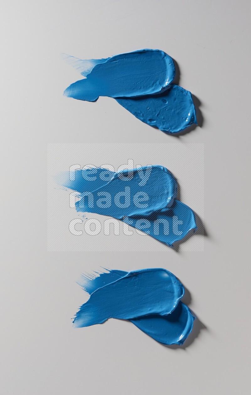 Blue painting knife strokes on white background