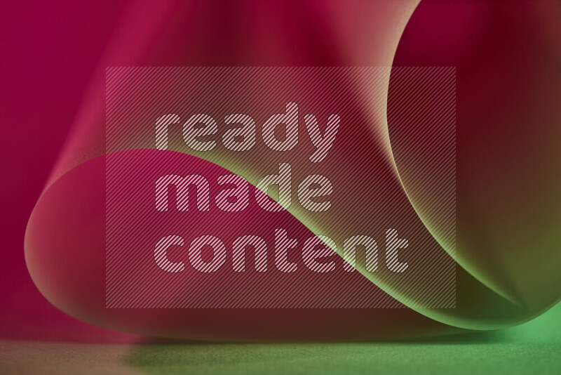 An abstract art piece displaying smooth curves in green and red gradients created by colored light