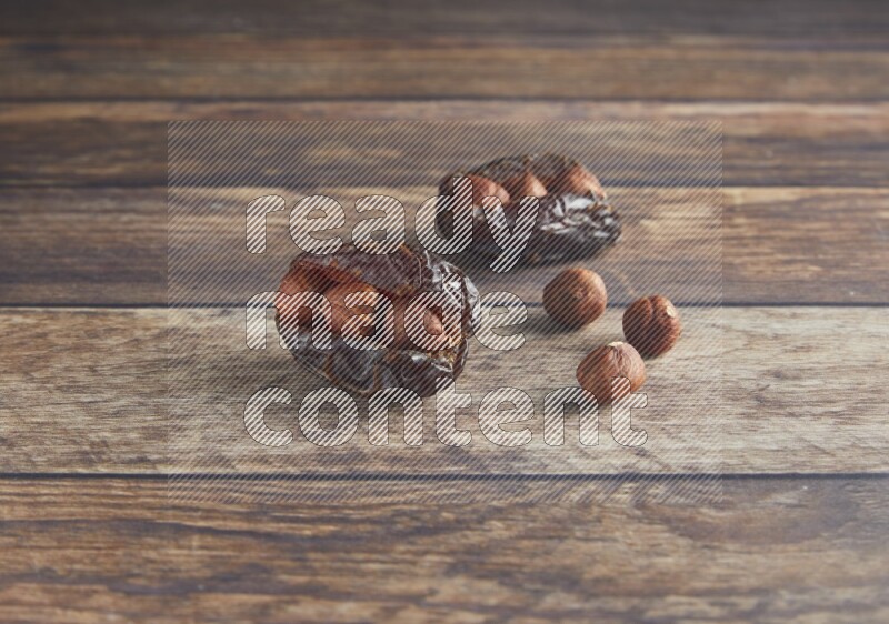 two hazelnut stuffed madjoul date on a wooden background