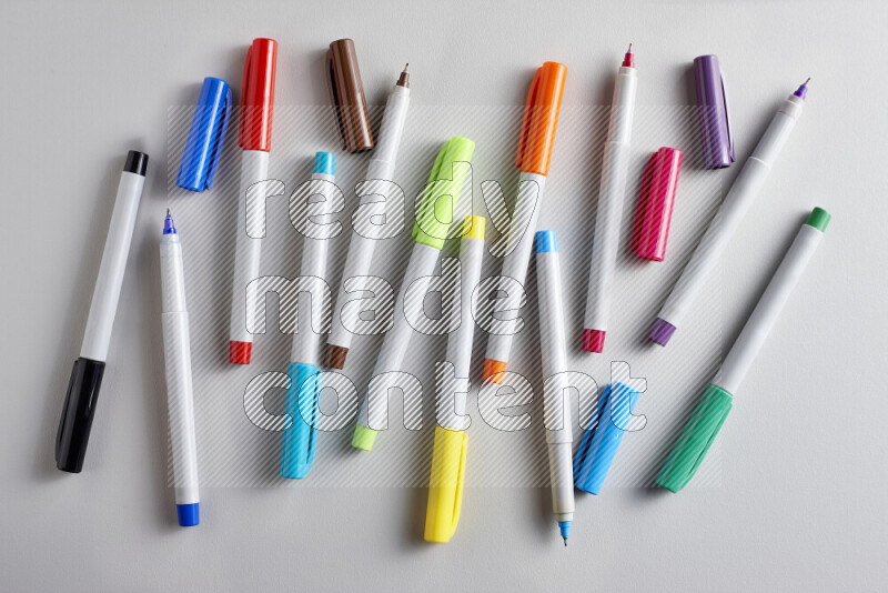 An arrangement of coloring pens in different colors on grey background