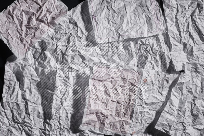 Crumpled notebook sheet on black background