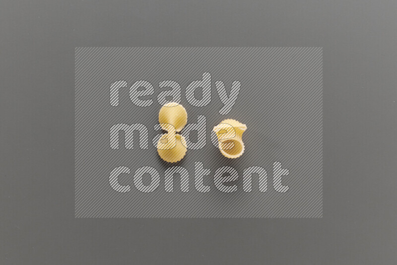 Fiocchi pasta with other types of pasta on grey background
