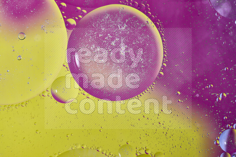 Close-ups of abstract oil bubbles on water surface in shades of yellow and pink