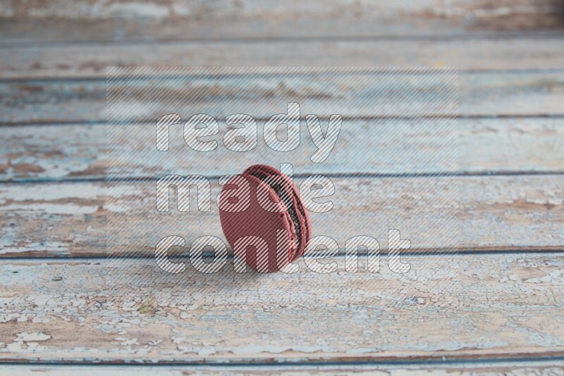 45º Shot of Red Cherry macaron on light blue wooden background