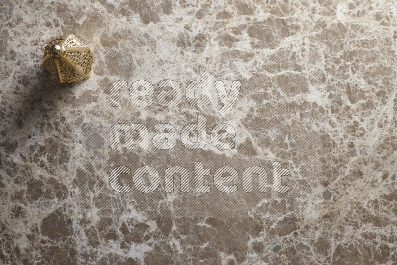 A lantern placed on a beige marble background