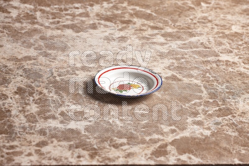 A vintage metal plate on beige marble background