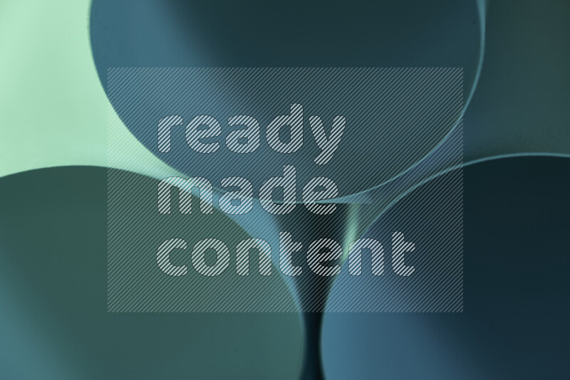 The image shows an abstract paper art with circular shapes in varying shades of green and blue