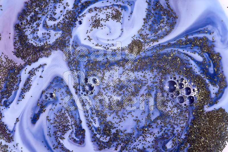 لقطة مقربة لبريق ذهبي متلألئ منتشر على خلفية من اللون الأزرق والأحمر في حركات دائرية