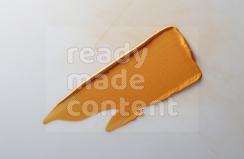 An orange straight painting knife stroke on white background