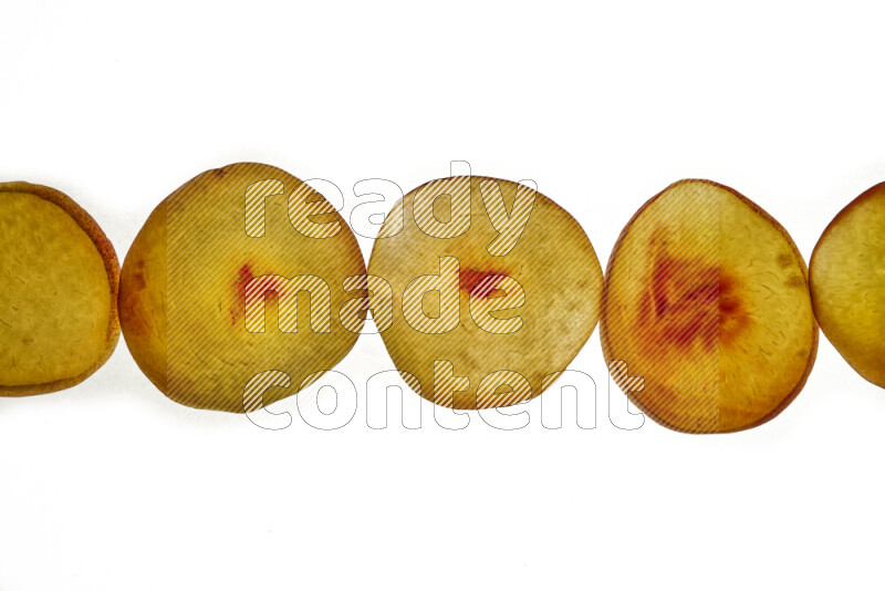 Peach slices on illuminated white background