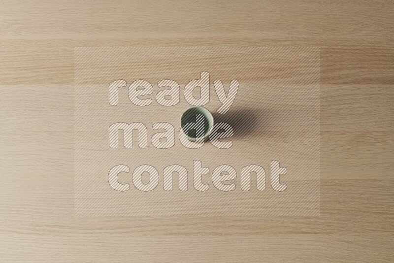 A pottery cup on light wooden background