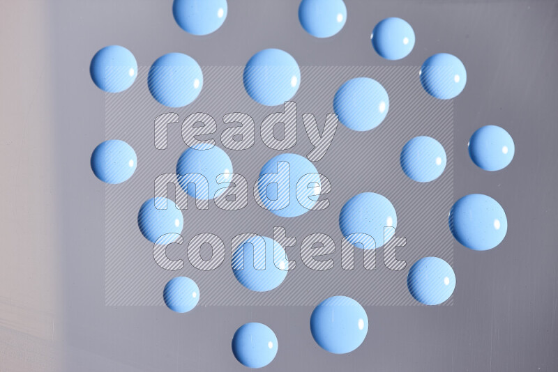 Close-ups of abstract blue paint droplets on the surface