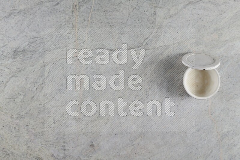 A multicolored pottery Cup on grey marble background