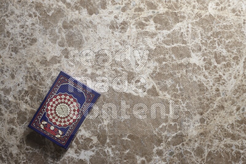 The holy Quran on beige marble background