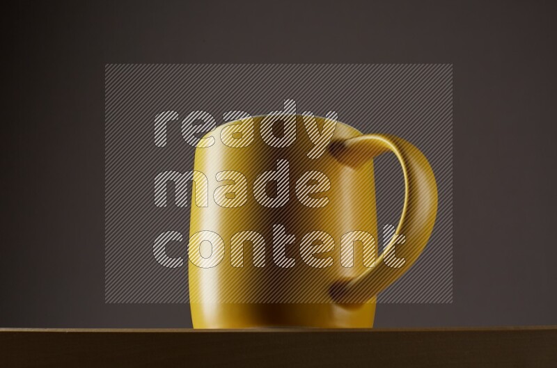 Low angle shot of a yellow cup on grey background