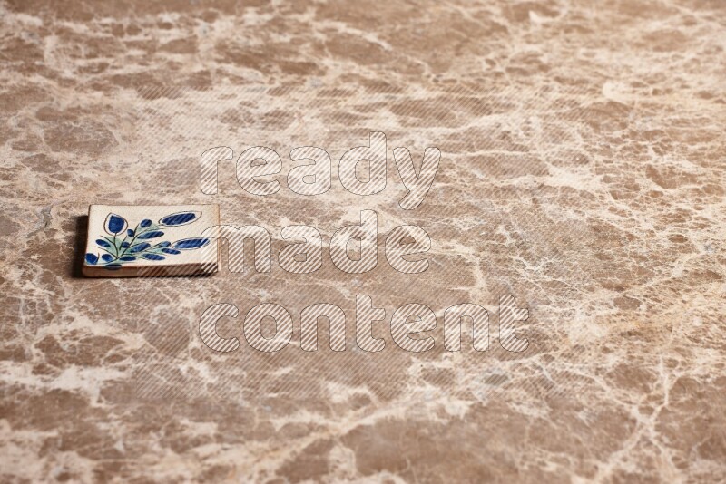 A decorative coaster on beige marble background