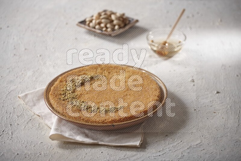 Konafa with nuts and honey in a light setup