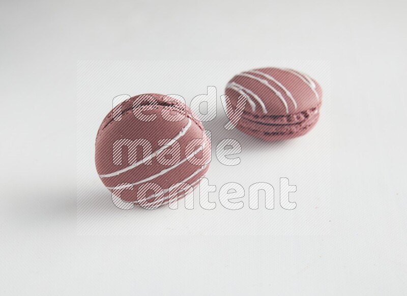 45º Shot of two Red Poppy Flower macarons on white background