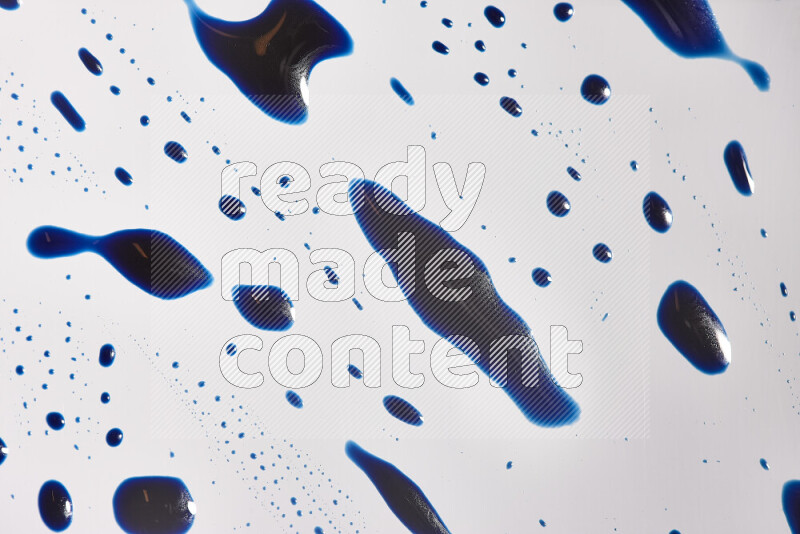 Close-ups of abstract blue paint droplets on the surface