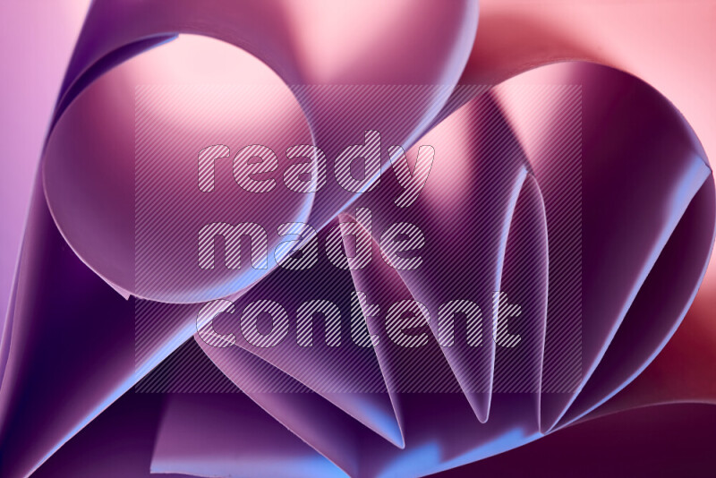 An artistic display of paper folds creating a harmonious blend of geometric shapes, highlighted by soft lighting in purple tones