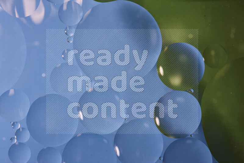 Close-ups of abstract oil bubbles on water surface in shades of blue and green